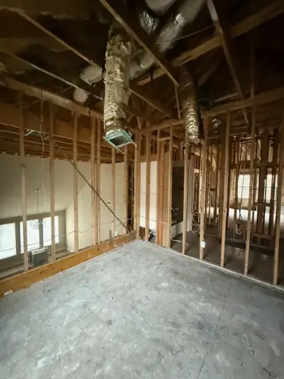 A room opened to the studs with the ceiling removed after a water loss, ready for drying
