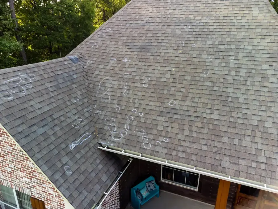 Chalk circles mark hail hits on a brick home's shingle roof, an example for Allen storm checks