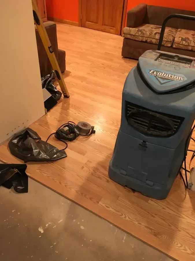 Dehumidifier running in an Allen room where part of the wood flooring was removed