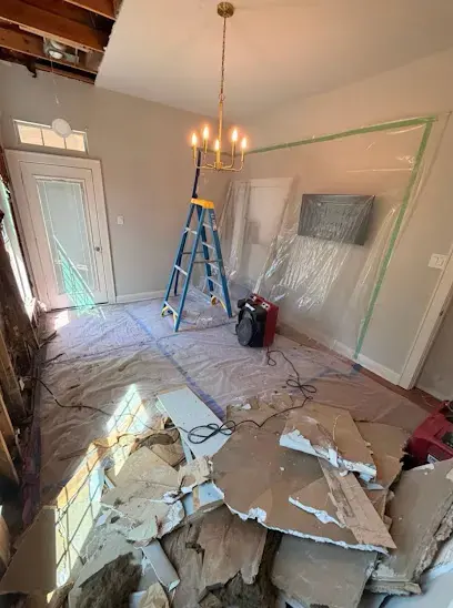 Dehumidifier and plastic containment in a room with fallen ceiling drywall during a Frisco, TX dry-out