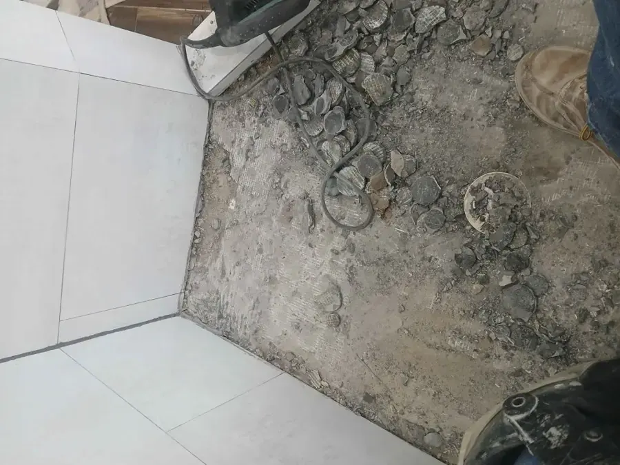 Concrete slab broken open beside cut tile to reach a leaking pipe, a typical slab leak repair in Allen, TX