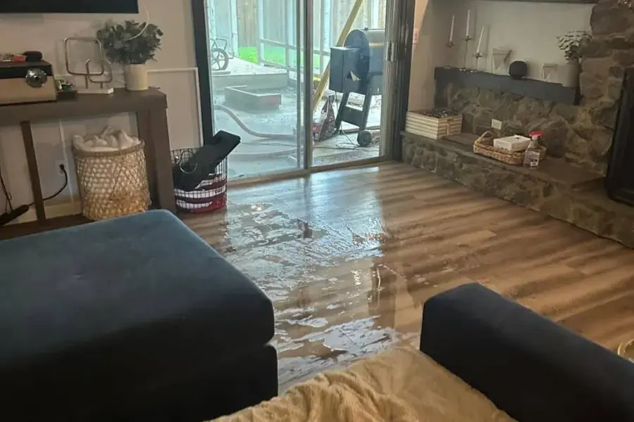 Standing water covering a living room floor before extraction in Prosper, TX